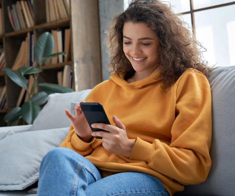 Happy female looking at her laptop