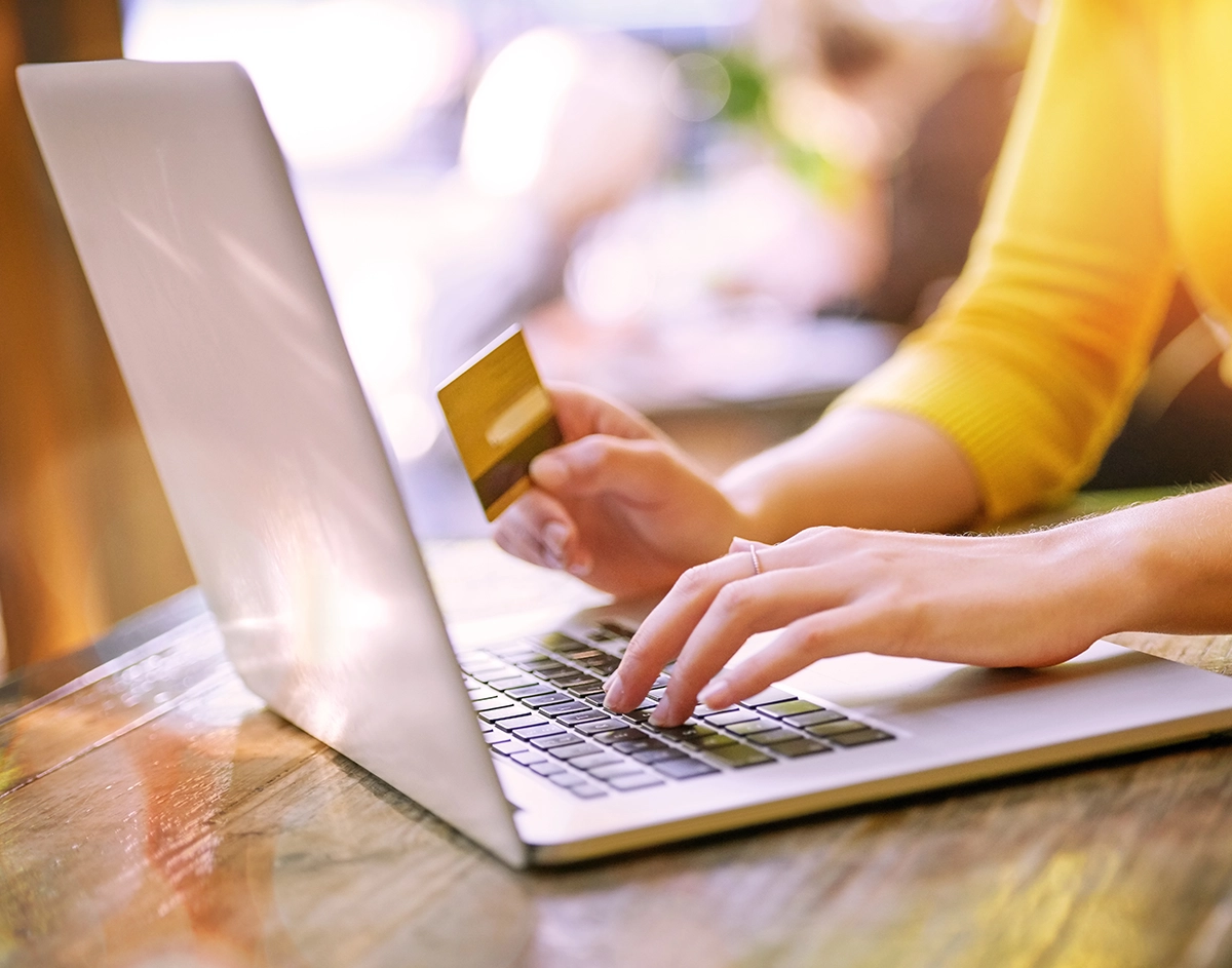 Woman completing a standard ACH transfer on her laptop