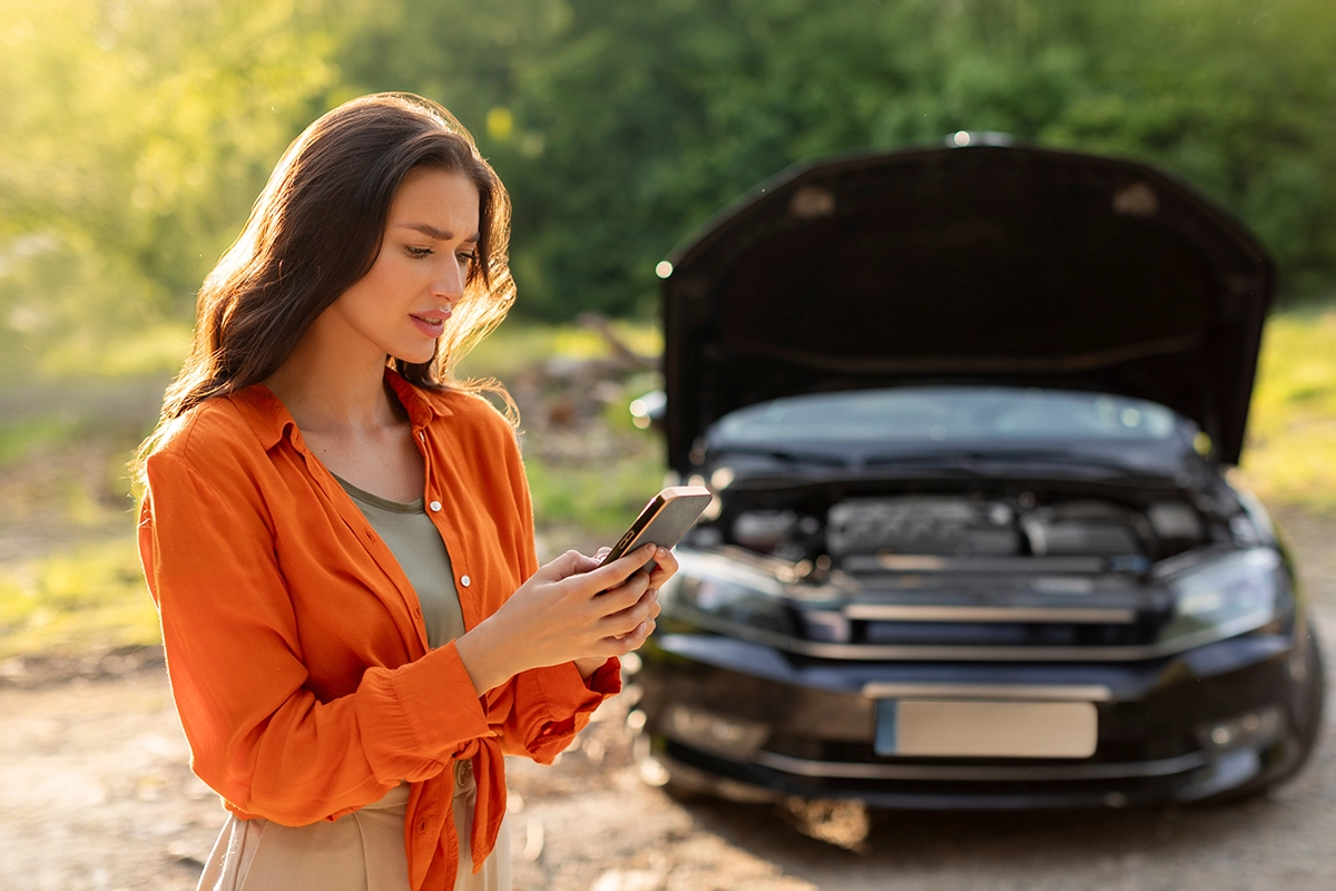Payday Loan Auto Repair Emergency Call A woman making an emergency call after her car breaks down
