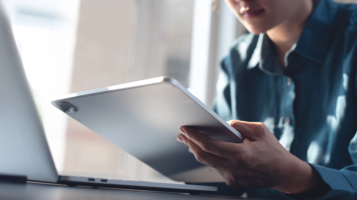 Person researching loan terms on their tablet