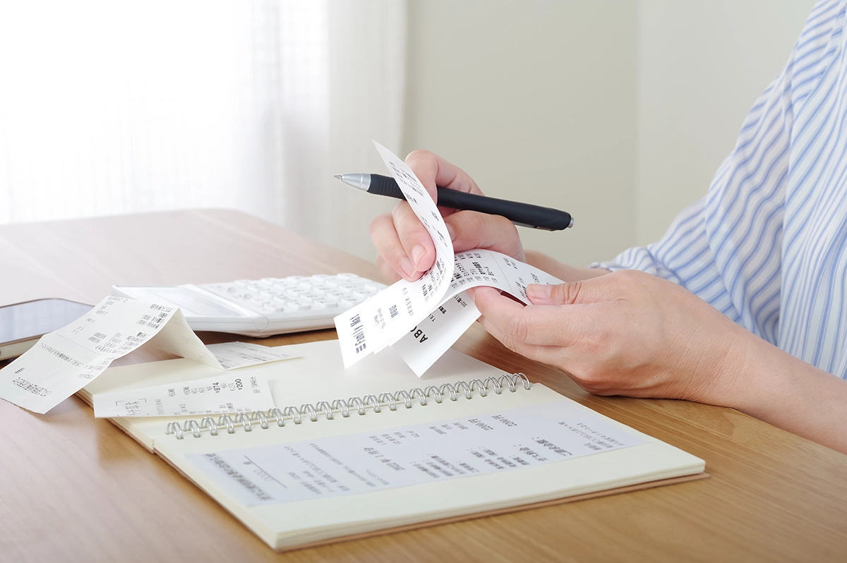 Someone managing their bills in between paychecks