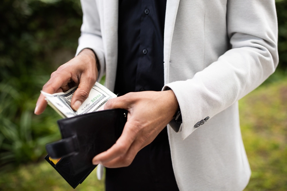 Someone opening their wallet