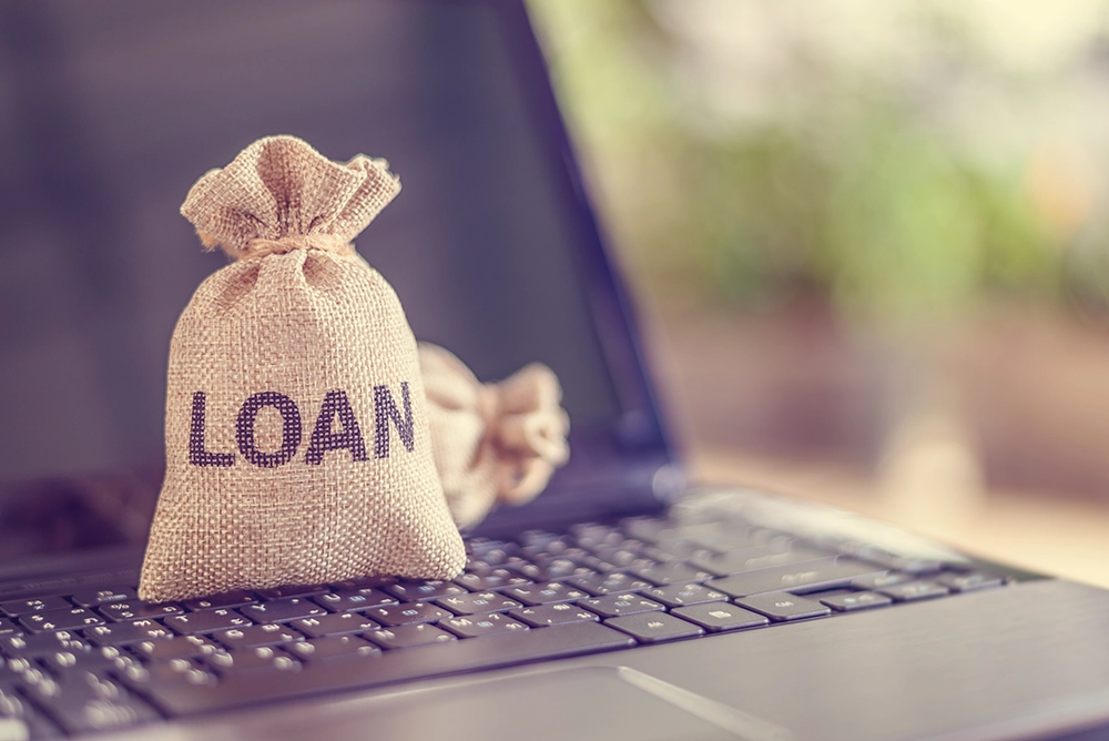 Loans on top of a laptop